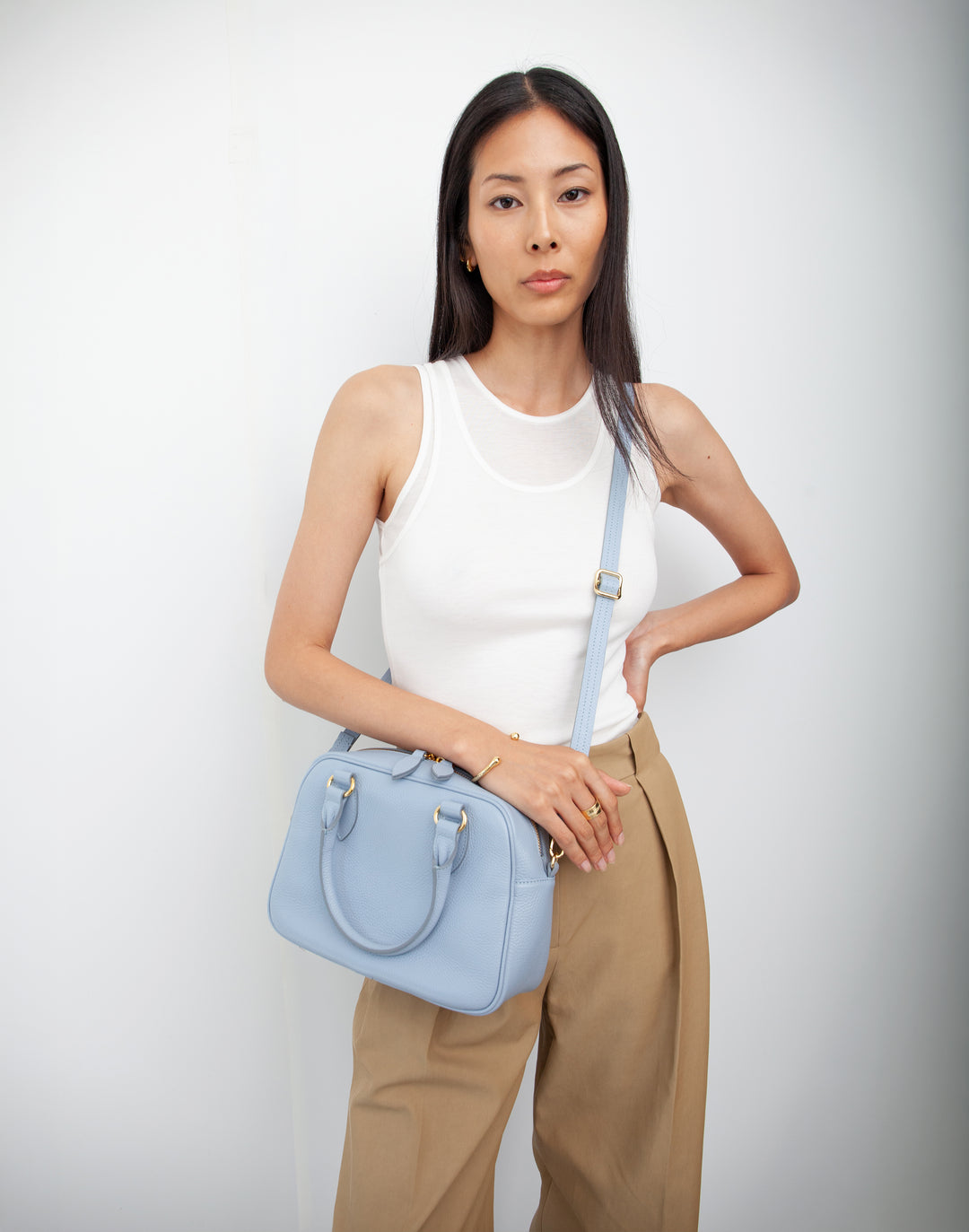 hyer goods la corsa pale blue leather bowling bag worn as a crossbody bag #color_pale-blue