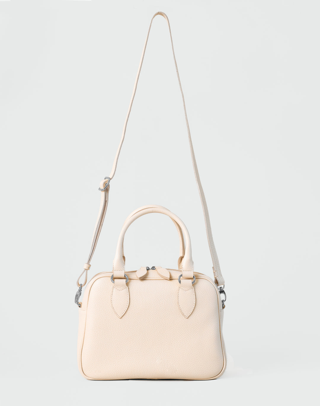 hyer goods la corsa off-white leather bowling bag front view with crossbody strap bone with silver hardware #color_bone 