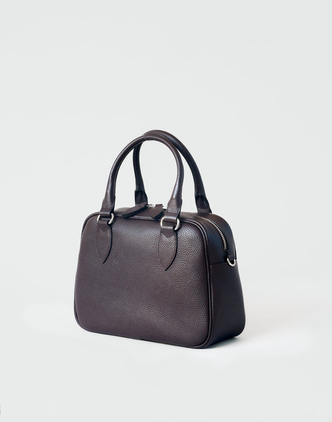 hyer goods la corsa dark brown leather bowling bag 3/4 view dark chocolate with silver hardware #color_dark-chocolate
