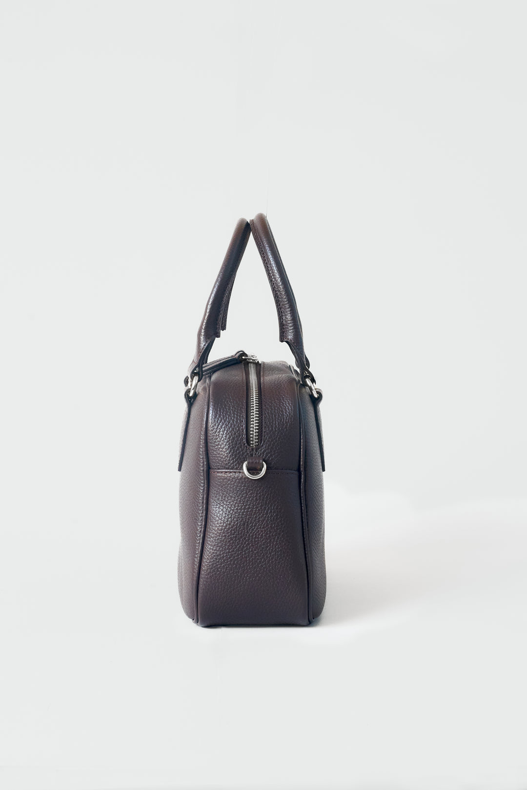 hyer goods la corsa dark brown leather bowling bag side view dark chocolate with silver hardware #color_dark-chocolate