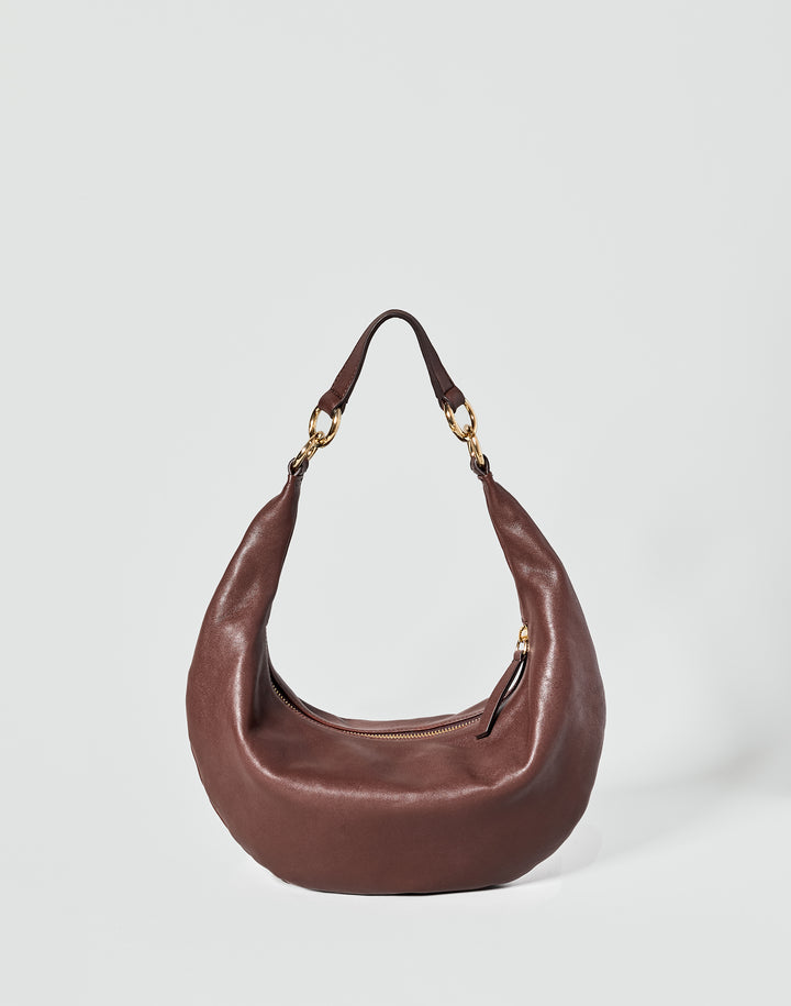 A brown leather crescent-shaped shoulder bag with gold-tone hardware and a single strap, photographed against a light gray studio background.#color_bordeaux-vintage