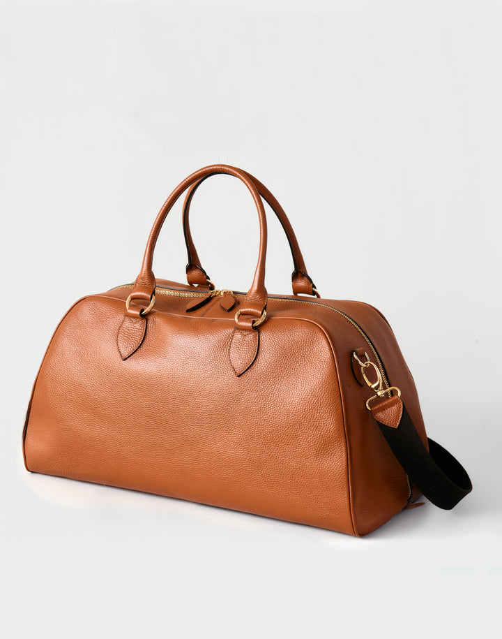 HYER GOODS tan leather la via weekender duffel bag front view with extra long strap #color_cognac