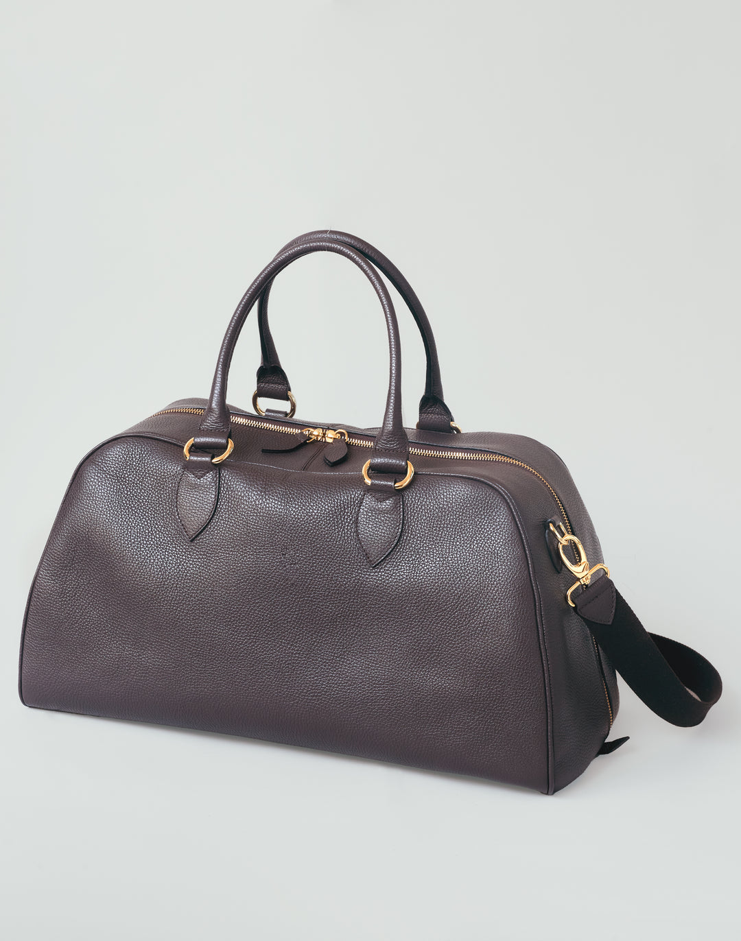 HYER GOODS dark brown leather la via weekender duffel bag front view with long strap #color_dark-chocolate