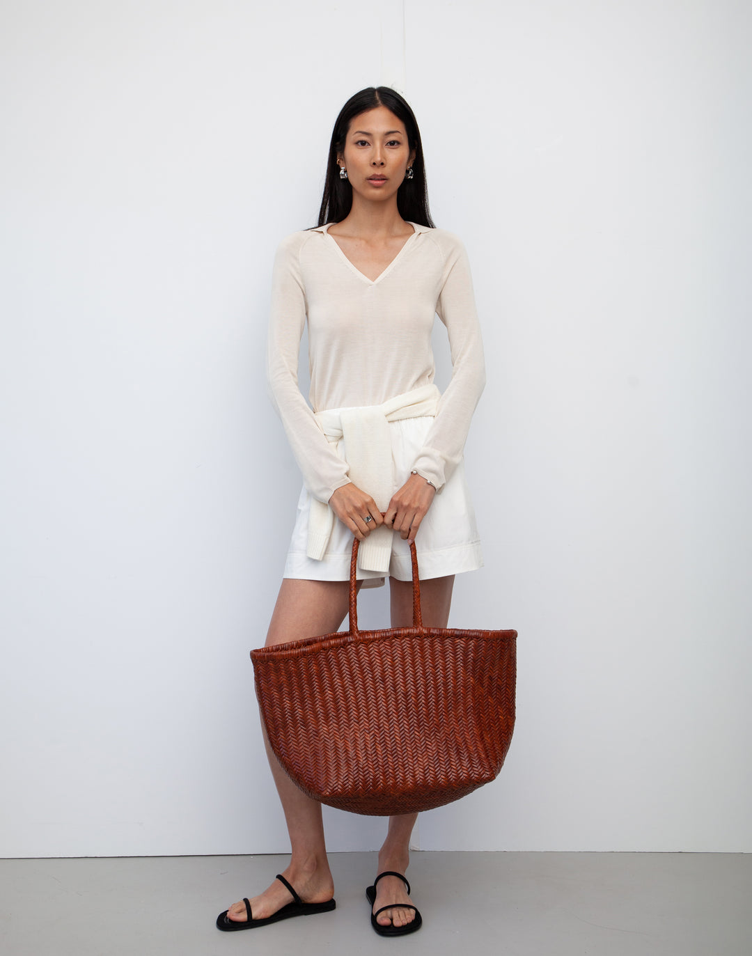 hyer goods tan woven leather oversized mercato summer tote bag held down by side #color_tan